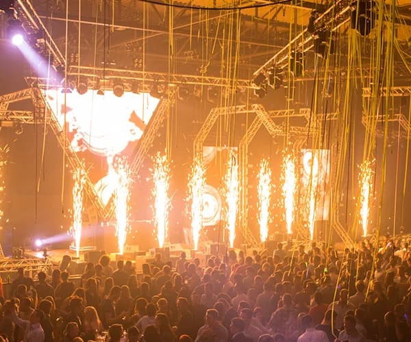 Escenario de concierto iluminado con efectos pirotécnicos